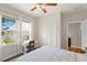 Well-lit bedroom with a desk, closet, hardwood floors, and views of the neighborhood at 626 16Th Ne Ave, St Petersburg, FL 33704