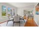 Bright dining room with hardwood floors, modern light fixtures and a view of the living area for open-concept living at 626 16Th Ne Ave, St Petersburg, FL 33704