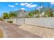 Detached garage with white privacy fence and landscaped driveway at 626 16Th Ne Ave, St Petersburg, FL 33704