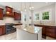 Updated kitchen with stainless steel appliances, granite countertops, custom hood, and a kitchen island at 626 16Th Ne Ave, St Petersburg, FL 33704