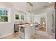 Bright kitchen with stainless steel appliances, granite countertops, and an island, flowing into the dining room at 626 16Th Ne Ave, St Petersburg, FL 33704