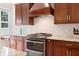 Updated kitchen with modern appliances, granite countertops, custom cabinets, and a stylish tile backsplash at 626 16Th Ne Ave, St Petersburg, FL 33704