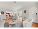Bright living room with hardwood floors, neutral furniture, and views into the kitchen and sunroom at 626 16Th Ne Ave, St Petersburg, FL 33704