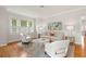 Living room featuring hardwood floors, neutral furniture, and natural light from the windows at 626 16Th Ne Ave, St Petersburg, FL 33704