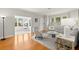 Hardwood floors and neutral decor in a living room with views into the sunroom at 626 16Th Ne Ave, St Petersburg, FL 33704