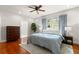 Spacious bedroom with hardwood floors, ceiling fan, blue bedding, and natural light at 626 16Th Ne Ave, St Petersburg, FL 33704