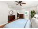 Spacious main bedroom featuring wood floors, ceiling fan, walk-in closet, and ensuite bathroom at 626 16Th Ne Ave, St Petersburg, FL 33704