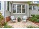 Outdoor patio area with two white Adirondack chairs and decorative plants at 626 16Th Ne Ave, St Petersburg, FL 33704