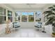 Bright sunroom featuring tile flooring, large windows, and comfortable seating, perfect for enjoying natural light at 626 16Th Ne Ave, St Petersburg, FL 33704