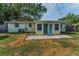 Backyard featuring a patio area with double doors leading into the home, great for entertaining at 629 Lexington St, Dunedin, FL 34698