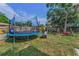 Backyard featuring a trampoline with safety net and swing set, perfect for Gathering fun at 629 Lexington St, Dunedin, FL 34698