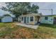 Backyard featuring a concrete patio, shed, and mature trees; great for relaxing and storage at 629 Lexington St, Dunedin, FL 34698