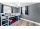Youthful bedroom has gray walls and a bunkbed next to a window at 629 Lexington St, Dunedin, FL 34698