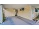 Well-lit covered carport with ceiling fan for comfortable parking and entry to the home at 629 Lexington St, Dunedin, FL 34698