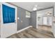 Inviting entryway with a white door, grey walls, vinyl floors, and natural light at 629 Lexington St, Dunedin, FL 34698