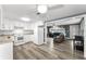 Bright kitchen featuring white cabinets, modern appliances, and an open layout to the living area at 629 Lexington St, Dunedin, FL 34698
