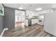Charming kitchen area featuring white cabinets and modern appliances with vinyl floors at 629 Lexington St, Dunedin, FL 34698