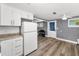 Bright kitchen area has tile backsplash and gray plank flooring at 629 Lexington St, Dunedin, FL 34698