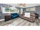 Cozy living room with stylish gray walls, wood-look floors, and comfortable seating at 629 Lexington St, Dunedin, FL 34698