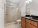 Modern bathroom with glass-enclosed shower, granite countertop vanity, and updated fixtures at 6820 Muncaster Ct, Tampa, FL 33625
