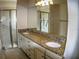 Bright bathroom features a double vanity with granite countertops, a large mirror, and a glass-enclosed shower, perfect for easy mornings at 6820 Muncaster Ct, Tampa, FL 33625