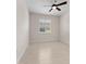 Simple bedroom showcasing a ceiling fan and window with plantation shutters at 6820 Muncaster Ct, Tampa, FL 33625