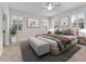 Bedroom with neutral tones, carpet, plantation shutters, and bench at the foot of the bed at 6820 Muncaster Ct, Tampa, FL 33625