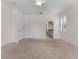 Large bedroom with carpet, neutral walls, view into Primary bathroom, and multiple windows with plantation shutters at 6820 Muncaster Ct, Tampa, FL 33625