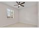 Bright bedroom featuring a modern ceiling fan and a window with plantation shutters at 6820 Muncaster Ct, Tampa, FL 33625