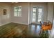 Sunlit bedroom features hardwood floors, a view of the outdoors, and a classic desk, perfect for a home office setup at 6820 Muncaster Ct, Tampa, FL 33625