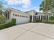 Charming single-story home with a manicured lawn, two-car garage, and beautifully maintained landscaping at 6820 Muncaster Ct, Tampa, FL 33625