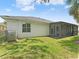 Exterior view of the home featuring a well maintained lawn and partial view of screen patio at 6820 Muncaster Ct, Tampa, FL 33625