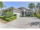 Charming single-story home featuring a well-manicured lawn, palm trees, and an attached two-car garage with spacious driveway at 6820 Muncaster Ct, Tampa, FL 33625