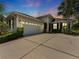 Charming single-story home featuring a spacious driveway, a two-car garage, and lush landscaping at 6820 Muncaster Ct, Tampa, FL 33625