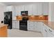 Modern kitchen with white cabinetry, granite countertops, stainless steel appliances, and stylish backsplash at 6820 Muncaster Ct, Tampa, FL 33625