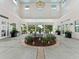 Interior of the community Lake House with ornate fountain, lush greenery, and seating areas at 6820 Muncaster Ct, Tampa, FL 33625
