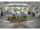 Lake House courtyard offers serene seating areas with a central fountain and lush greenery at 6820 Muncaster Ct, Tampa, FL 33625