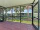 Screened-in lanai featuring tile floor, and views of the lush backyard at 6820 Muncaster Ct, Tampa, FL 33625