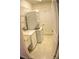 Convenient laundry room with a stacked washer and dryer, ample shelving, and a utility sink, offering practicality and functionality at 6820 Muncaster Ct, Tampa, FL 33625