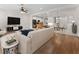 Open-concept living room with hardwood floors, a ceiling fan, and a view of the kitchen and dining area at 6820 Muncaster Ct, Tampa, FL 33625