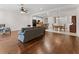 Bright living room with hardwood floors and an open layout to the kitchen and dining area at 6820 Muncaster Ct, Tampa, FL 33625