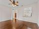 Open-concept space featuring hardwood floors and a view of the kitchen through a serving hatch at 6820 Muncaster Ct, Tampa, FL 33625