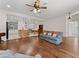 Spacious living room featuring hardwood floors and an open view to the kitchen and dining area at 6820 Muncaster Ct, Tampa, FL 33625