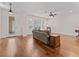 Inviting living room with hardwood floors, a ceiling fan, and plenty of natural light at 6820 Muncaster Ct, Tampa, FL 33625