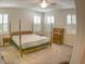 Spacious main bedroom with a four-poster bed, dresser, and plantation shutters, offering a comfortable and elegant retreat at 6820 Muncaster Ct, Tampa, FL 33625