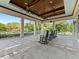 Comfortable outdoor patio with rocking chairs, ceiling fans, and relaxing backyard views at 6820 Muncaster Ct, Tampa, FL 33625