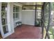 Enclosed patio with red brick flooring, perfect for outdoor seating and entertaining at 6820 Muncaster Ct, Tampa, FL 33625