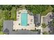 Aerial view of a community pool surrounded by ample seating, sun loungers and shade structures for relaxation at 6820 Muncaster Ct, Tampa, FL 33625
