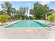Outdoor pool with crystal clear water with several lounge chairs and lush landscaping at 6820 Muncaster Ct, Tampa, FL 33625