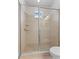 Walk-in shower featuring tile surround, multiple shower heads, and glass door at 6820 Muncaster Ct, Tampa, FL 33625
